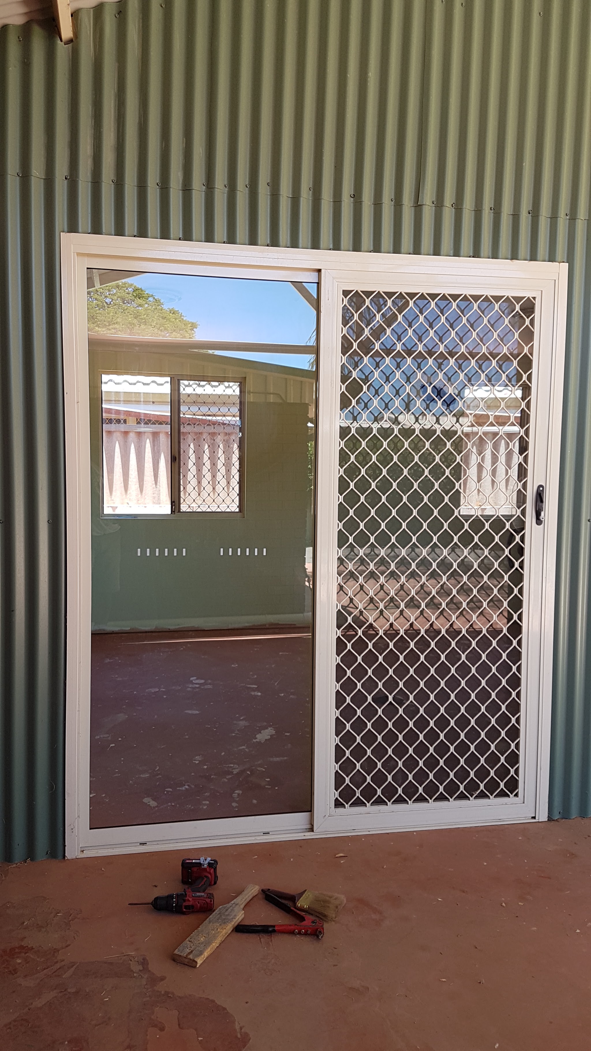 A new sliding glass door fitted into the wall of a Geraldton home